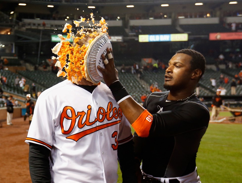 BALTIMORE, MARYLAND - APRIL 04: Adam Jones #10 (R) hits Matt Wieters #32 of the Baltimore Orioles in the face with pie after the Orioles defeated the Minnesota Twins 3-2 during their Opening Day game Oriole Park at Camden Yards on April 4, 2016 in Baltimore, Maryland. (Photo by Rob Carr/Getty Images)