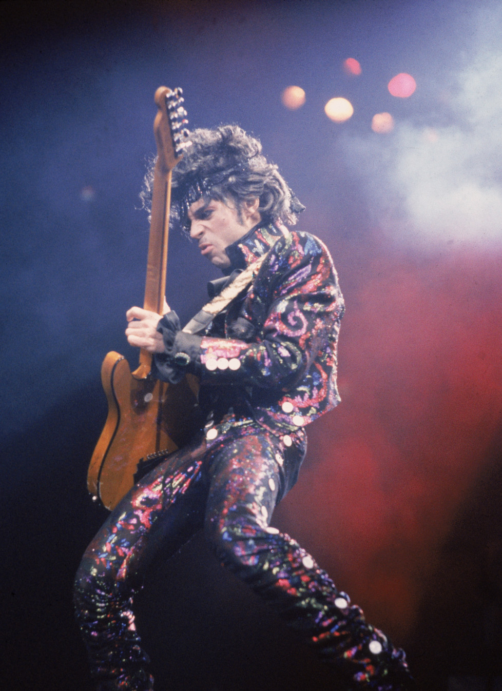 American rock singer and songwriter Prince plays guitar on stage during a concert, 1985. (Photo by Frank Micelotta/Getty Images)