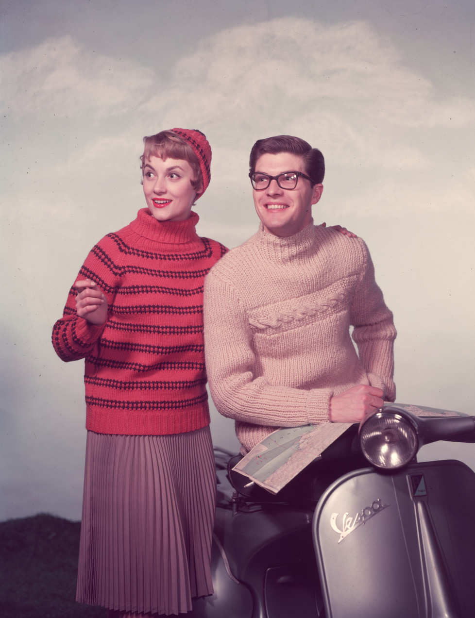 circa 1955: A chic couple with a moped use a map to help plan their route. (Photo by Chaloner Woods/Getty Images)