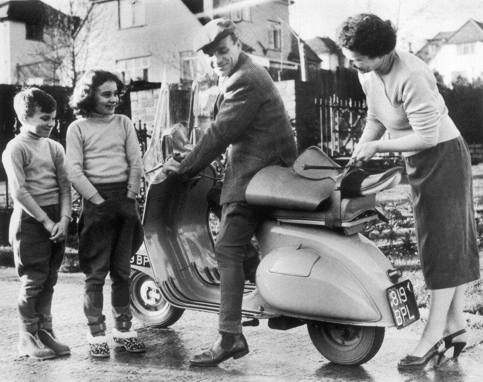 UNITED KINGDOM - JANUARY 09: January 9, 1957: A jockey by the name of Harry SPRAGUE climbing on his VESPA moped to go to the racetrack, while his children and wife stood by. He thought he was taking good measures in view of the possible oil shortage that was being talked about at that time. (Photo by Keystone-France/Gamma-Keystone via Getty Images)