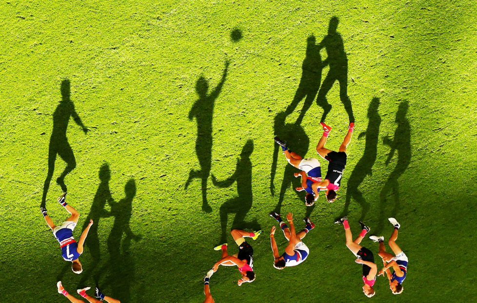 MELBOURNE, AUSTRALIA - MAY 15: (EDITORS NOTE: This image was rotated from its original perspective.) Long shadows are cast by players as Mitch Wallis of the Bulldogs passes the ball during the 2016 AFL Round 08 match between the Melbourne Demons and the Western Bulldogs at the Melbourne Cricket Ground, Melbourne on May 15, 2016. (Photo by Scott Barbour/AFL Media/Getty Images)