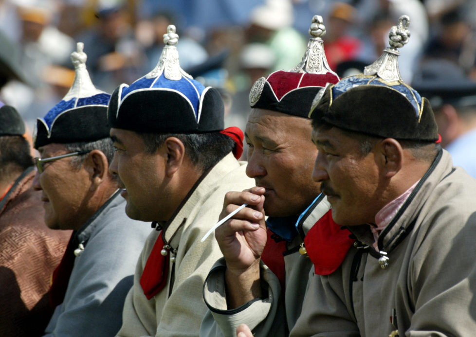 Elderly Mongolian wrestlers watch traditional wrestling matches during Naadam Festival July 12, 2003. Some 500 wrestlers from all over Mongolia competed in one of the highlights of Naadam. Naadam is the biggest event in the Mongolian calendar held July 11 to 13, on the anniversary of the Mongolian revolutionof 1921. - RTXM3KU