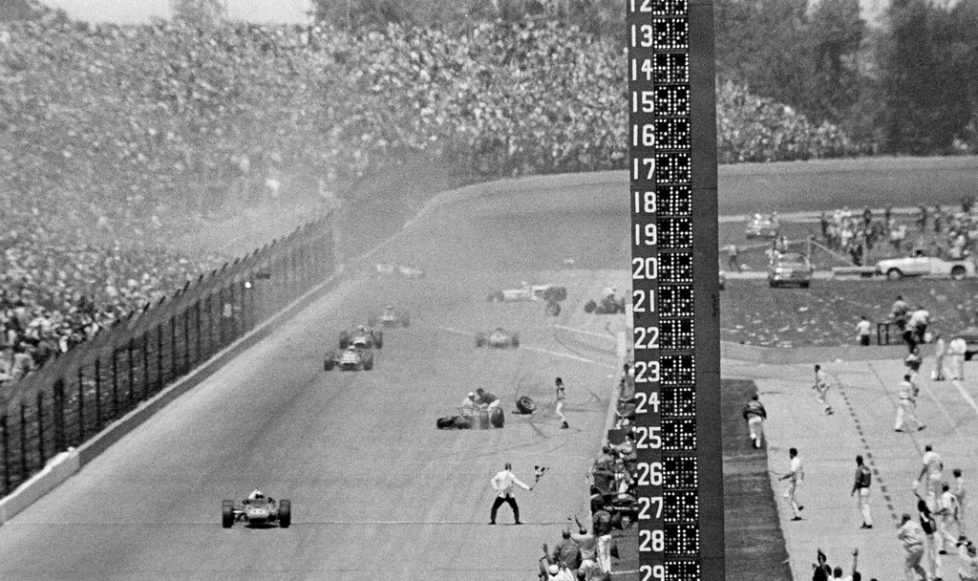 FILE - In this May 31, 1967, file photo, AJ Foyt, foreground left, drives his Coyote Ford past the checkered flag after avoiding a multi-car wreck on the last lap to win the Indianapolis 500 auto race at Indianapolis Motor Speedway in Indianapolis, Ind. (AP Photo/File)