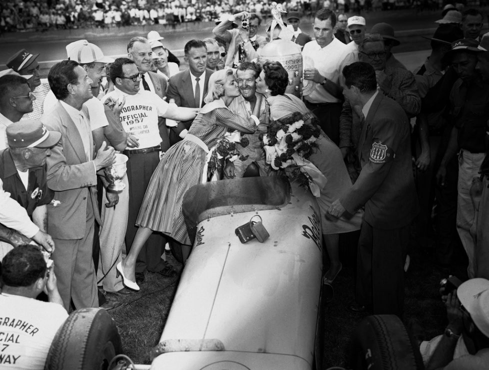 FILE - In this May 30, 1957, file photo, Sam Hanks is kissed by his wife, Alice, left, and movie actress Cyd Charisse, after winning the Indianapolis 500 auto race in Indianapolis, Ind. (AP Photo.File)