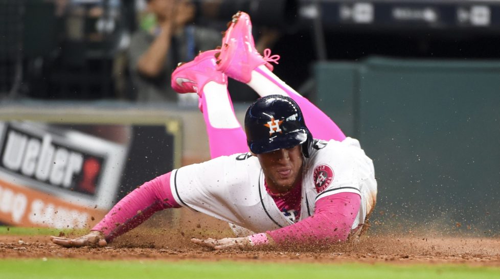 Houston Astros' George Springer slides safely home on Carlos Correa's RBI single in the seventh inning of a baseball game against the Seattle Mariners, Sunday, May 8, 2016, in Houston. (AP Photo/Eric Christian Smith)