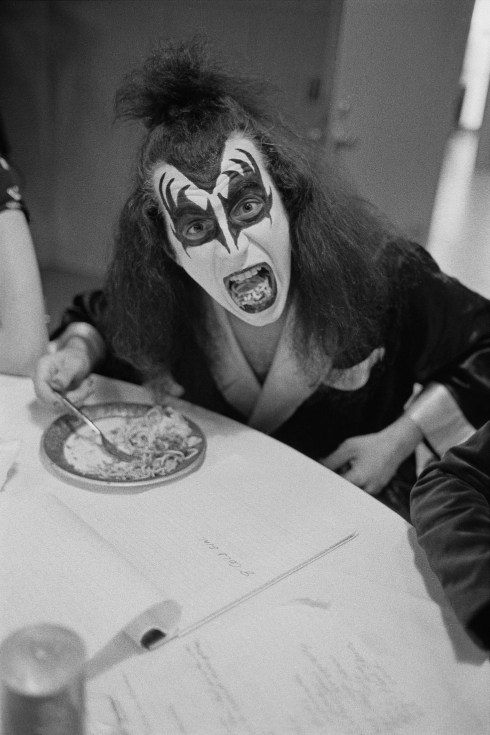 DETROIT, USA - 16th MAY: Bassist Gene Simmons from rock group Kiss posed eating a plate of Spaghetti backstage at Cobo Hall in Detroit during the concert recording of Alive! on 16th May 1975. (Photo by Fin Costello/Redferns)