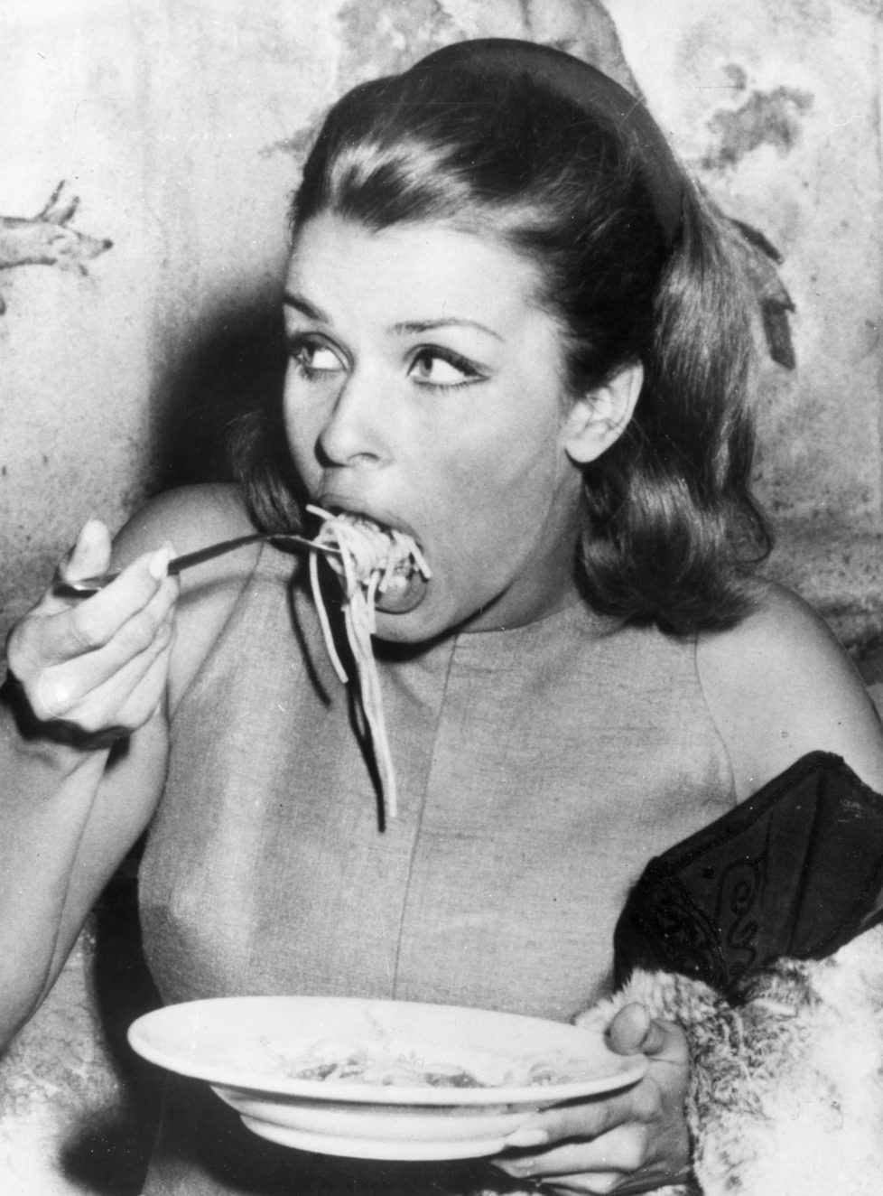 20th September 1966: Austrian actress, Senta Berger enjoying a plate of spaghetti at the Cinecitta in Rome during the filming of 8Operation Saint Gennarioe. (Photo by Keystone/Getty Images)