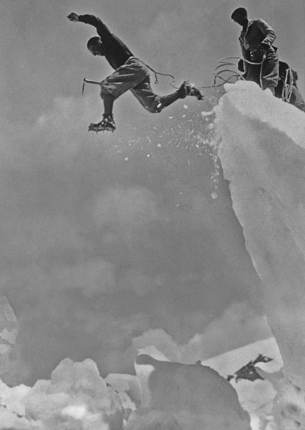 A Swiss mountaineer leaps over a crevasse in the Swiss Alps, 5th December 1930. (Photo by Henry Miller News Picture Service/Archive Photos/Getty Images)