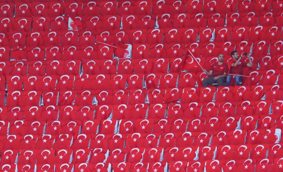 NICE, FRANCE - JUNE 17: Turkey fans sit with Turkish national flags prior to the UEFA EURO 2016 Group D match between Spain and Turkey at Allianz Riviera Stadium on June 17, 2016 in Nice, France. (Photo by Lars Baron/Getty Images)