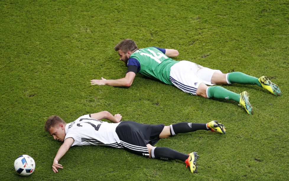epaselect epa05381813 Stuart Dallas (R) of Northern Ireland and Joshua Kimmich (L) of Germany lie on the pitch during the UEFA EURO 2016 group C preliminary round match between Northern Ireland and Germany at Parc des Princes in Paris, France, 21 June 2016. (RESTRICTIONS APPLY: For editorial news reporting purposes only. Not used for commercial or marketing purposes without prior written approval of UEFA. Images must appear as still images and must not emulate match action video footage. Photographs published in online publications (whether via the Internet or otherwise) shall have an interval of at least 20 seconds between the posting.) EPA/YOAN VALAT EDITORIAL USE ONLY