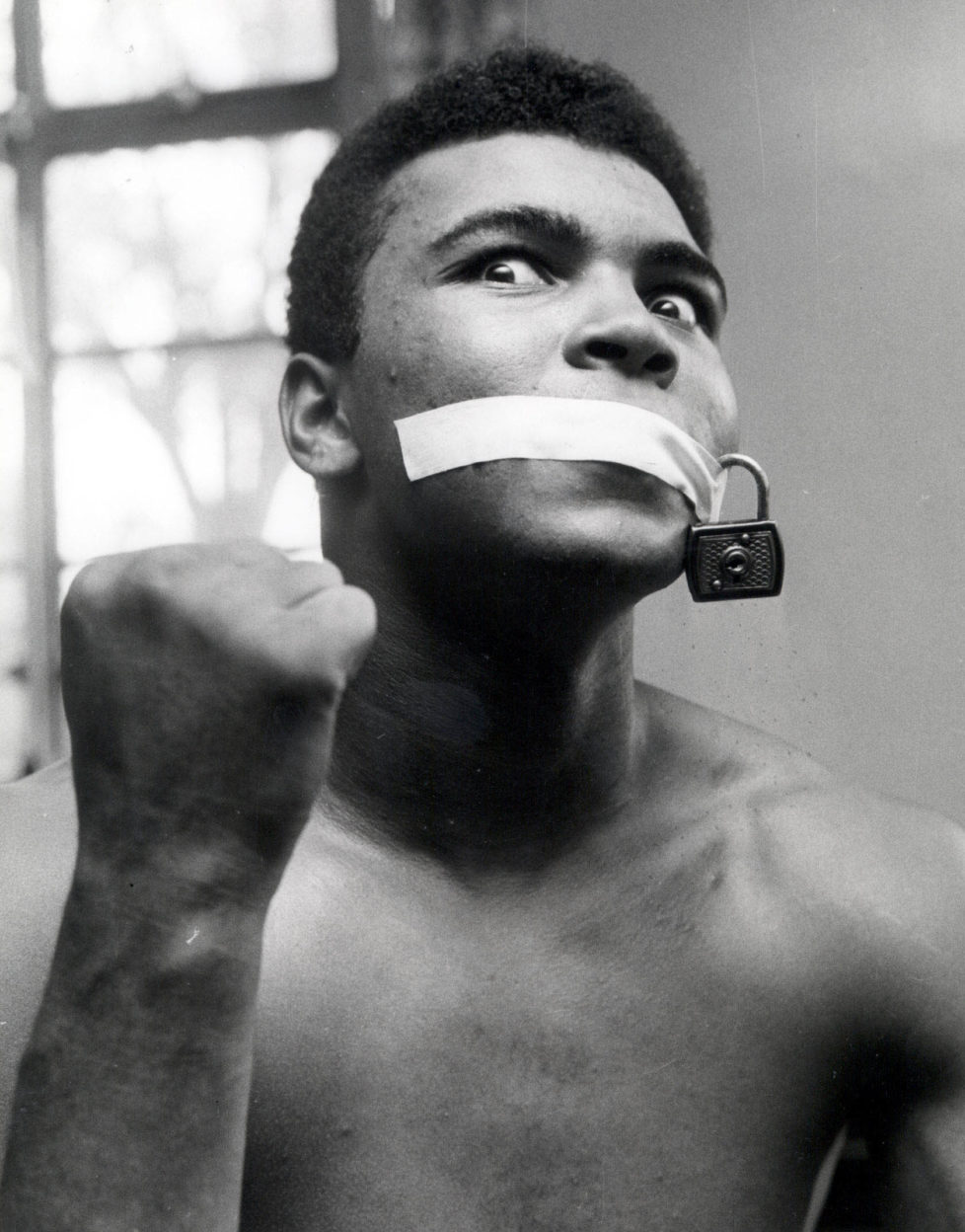 Boxing, 1963, Cassius Clay (later Muhammad Ali) is gagged with a piece of tape and a padlock (Photo by Bob Thomas/Getty Images)