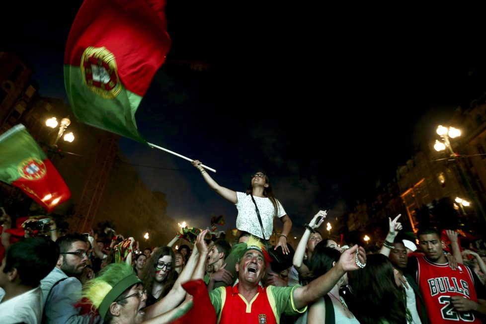 epa05411924 Supporters of Portugal celebrate during the public viewing of the UEFA EURO 2016 semi final match between Portugal vs Wales at Avenida dos Aliados, in Porto, Portugal, 06 July 2016. EPA/ESTELA SILVA