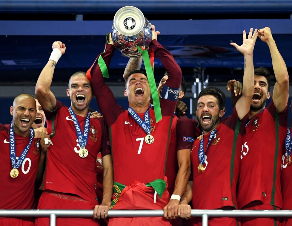 PARIS, FRANCE - JULY 10: Cristiano Ronaldo of Portugal (c) lifts the Henri Delaunay trophy after his side win 1-0 against France during the UEFA EURO 2016 Final match between Portugal and France at Stade de France on July 10, 2016 in Paris, France. (Photo by Matthias Hangst/Getty Images)