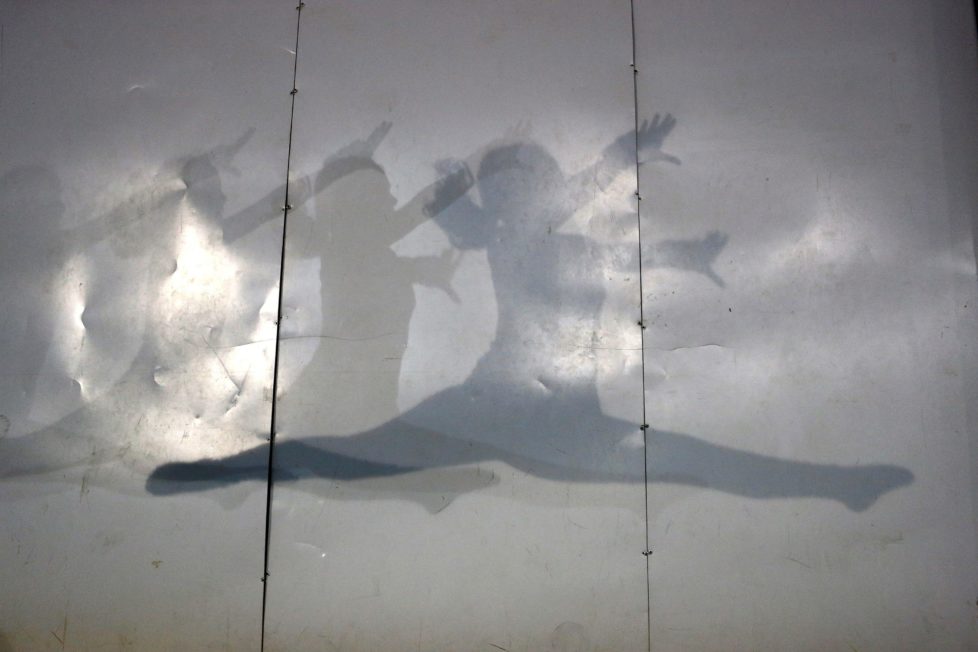 Shadows of a gymnast are cast on a wall during a training session at the school-gym of Tomas Gonzalez, the first Chilean gymnast to qualify twice for the Olympics, in Santiago, Chile July 20, 2016. Picture taken July 20, 2016. REUTERS/Ivan Alvarado