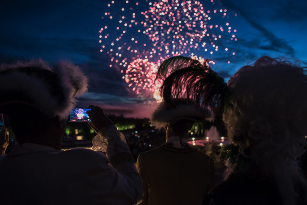 Costumed guests watch fireworks before the Great Masked Bal, in the Versailles castle, west of Paris, Saturday, June 27, 2015. On the occasion of the tercentenary of King Louis XIVs death, who died on Sept.1, 1715, a fountains show and a costumed ball took place in the castle.(AP Photo/Kamil Zihnioglu)