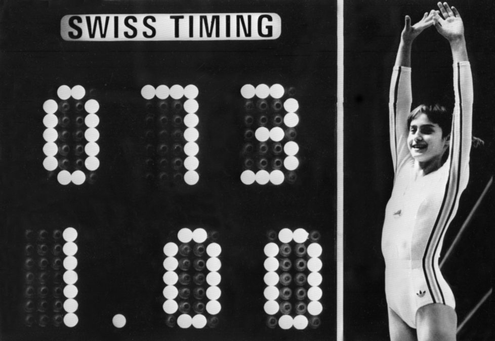 Rumanian champion Nadia Comaneci, aged 14, jubilates when scoreboard shows the perfect score of 10 during Olympic Games 19 July 1976 in Montreal after her acrobatic compulsory at uneven bars. She was awarded with ten points in two exercices and captured 3 gold medals (beam, uneven bars and general competition). Legendary gymnast, during her career Nadia Comaneci captured four Olympic gold medals (1976 : beam, uneven bars and general competition - 1980, beam) and was the first to score 10 in her discipline. / AFP PHOTO