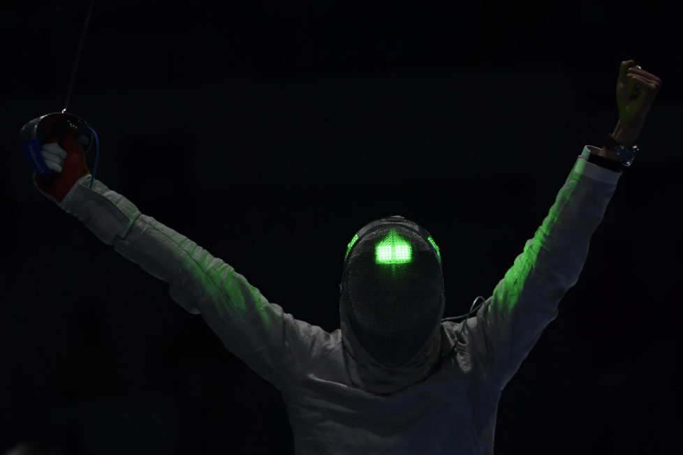 South Korea's Kim Junghwan celebrates after beating Georgia's Sandro Bazadze in their men's individual sabre table of 16 bout as part of the fencing event of the Rio 2016 Olympic Games at the Carioca Arena 3 in Rio de Janeiro on August 10, 2016. / AFP PHOTO / Fabrice COFFRINI