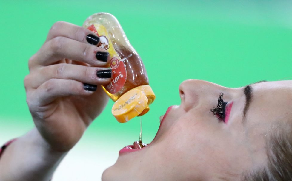 2016 Rio Olympics - Artistic Gymnastics - Final - Women's Individual All-Around Final - Rio Olympic Arena - Rio de Janeiro, Brazil - 11/08/2016. Carlotta Ferlito (ITA) of Italy drinks honey before her routine on the vault. REUTERS/Mike Blake FOR EDITORIAL USE ONLY. NOT FOR SALE FOR MARKETING OR ADVERTISING CAMPAIGNS.