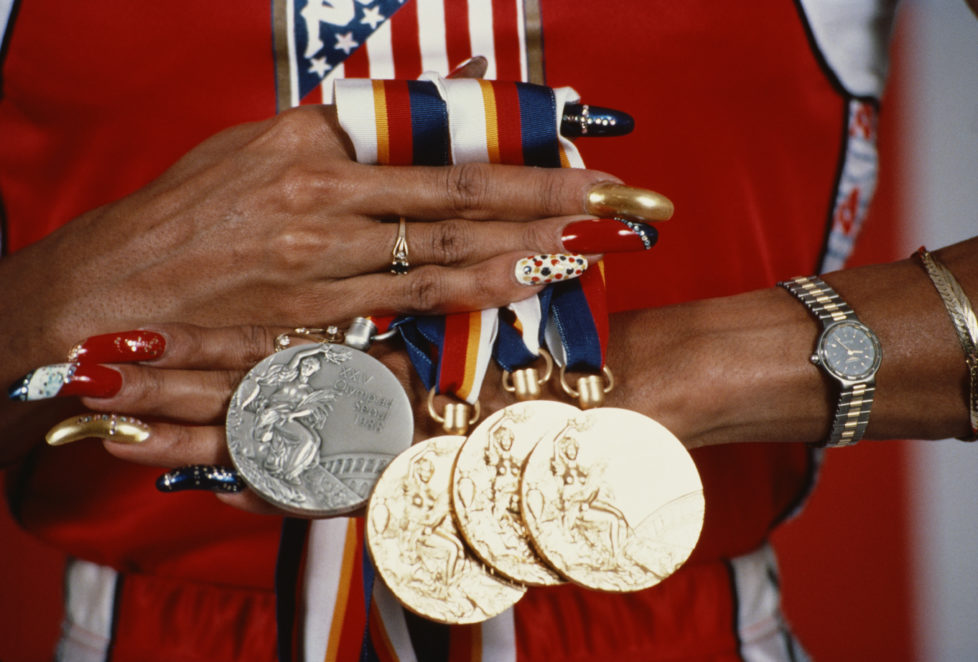 Oct 1988: Florence Griffith-Joyner of the USA displays her three gold medals and a silver medal that she won at the 1988 Summer Olympics in Seoul, Korea. Griffith-Joyner won gold medals in the 100m, 200m and the 4x100m relay. Mandatory Credit: Tony Du