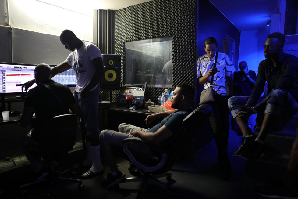 Friends of rapper Worms-T listen to him record a new song in a studio in Pantin, France, August 24, 2016. REUTERS/Joe Penney SEARCH "CREATIVE BANLIEUE" FOR THIS STORY. SEARCH "WIDER IMAGE" FOR ALL STORIES. THE IMAGES SHOULD ONLY BE USED TOGETHER WITH THE STORY - NO STAND-ALONE USES.