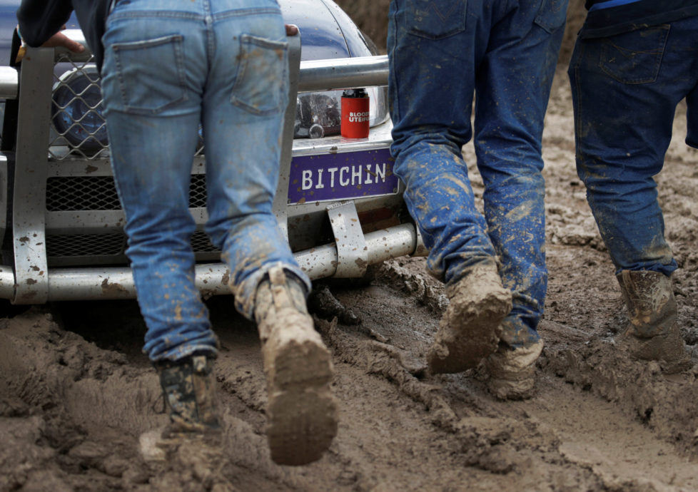 Volunteers push a bogged Australian ute out of the mud during the 'circle work' competition at the Deni Ute Muster in Deniliquin, New South Wales, Australia, October 1, 2016. REUTERS/Jason Reed SEARCH "UTE CULTURE" FOR THIS STORY. SEARCH "THE WIDER IMAGE" FOR ALL STORIES.