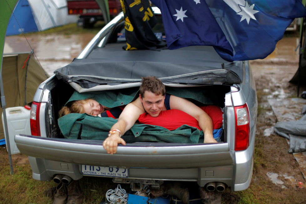 Australian couple Darren McGarvie, 27, and Nicole York, 24, wake up after spending the night together in McGarvie's Holden Commodore Ute at the Deni Ute Muster in Deniliquin, New South Wales, Australia, October 1, 2016. REUTERS/Jason Reed SEARCH "UTE CULTURE" FOR THIS STORY. SEARCH "THE WIDER IMAGE" FOR ALL STORIES.