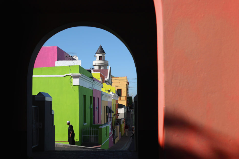CAPE TOWN, SOUTH AFRICA - OCTOBER 20: A man walks through the Bo-Kaap area of Cape Town on October 20, 2009 in Cape Town, South Africa. The Bo-Kaap area is a predominantly Muslim area of Cape Town with brightly coloured painted houses that line many of the streets.. (Photo by Dan Kitwood/Getty Images)