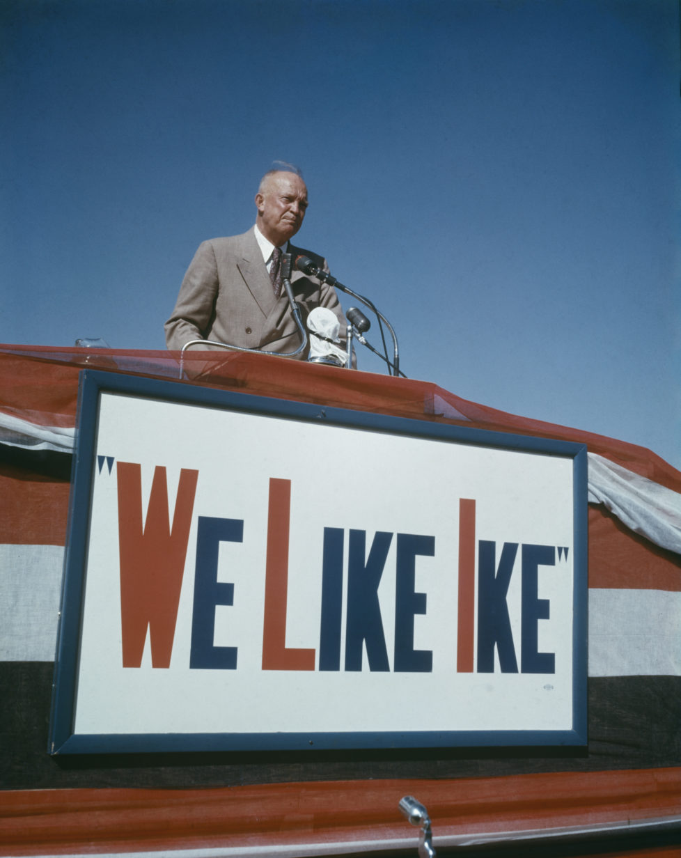American General Dwight D Eisenhower (1890-1969) speaks on a podium above a sign declaring 'We Like Ike' during his presidential election campaign in Lubbock, Texas in October 1952. (Photo by Rolls Press/Popperfoto/Getty Images) *** Local Caption *** Dwight D. Eisenhower