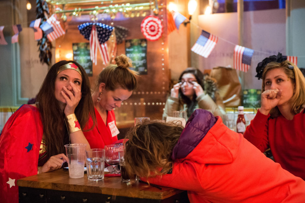 LONDON, ENGLAND - NOVEMBER 09: American Democratic Party supporters, one in a Wonder Woman costume, react to the news that Donald Trump has won the state of Florida at the Democrats Abroad election night party at Marylebone Sports Bar and Grill on November 9, 2016 in London, England. Americans go to the polls today to choose between Trump and Democrat Hillary Clinton for president. (Photo by Chris J Ratcliffe/Getty Images)