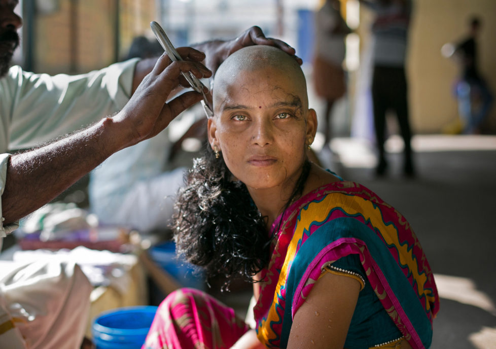 THIRUTTANI, INDIA - NOVEMBER 10: 28 year old Rupa has her hair shaven to donate to the Gods at the Thiruthani Murugan Temple November 10, 2016 in Thiruttani, India. Rupa donated her hair with the wish that her daughter's illness is cured. The process of shaving ones hair and donating it to the Gods is known as tonsuring. It is common for Hindu believers to tonsure their hair at a temple as a young child, and also to celebrate a wish coming true, such as the birth of a baby or the curing of an illness. The "temple hair", as it's known, is then auctioned off to a processing plant and then sold as pricey wigs and weaves in the US, Europe and Africa. (Photo by Allison Joyce/Getty Images)