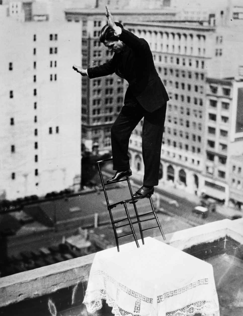 NEW YORK, NY - MARCH 25: French equilibrist Gilbert Bettancourt tests his balance on a chair resting on a table with only two legs, close to the edge of the building roof on March 25, 1932 in New York City. (Photo by Gamma-Keystone via Getty Images)